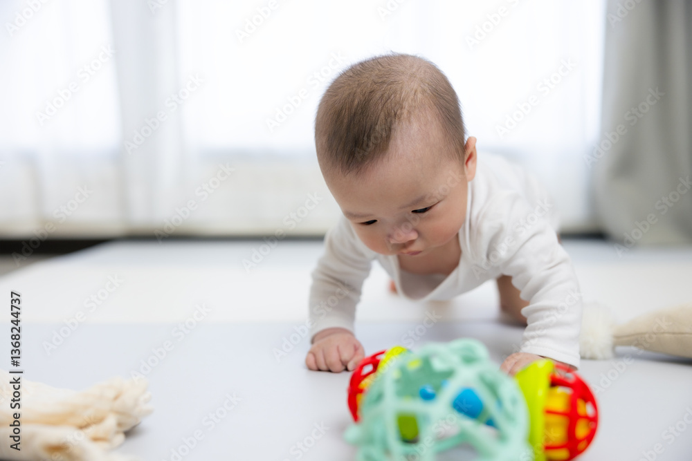 Adorable baby exploring a sensory toy indoors
