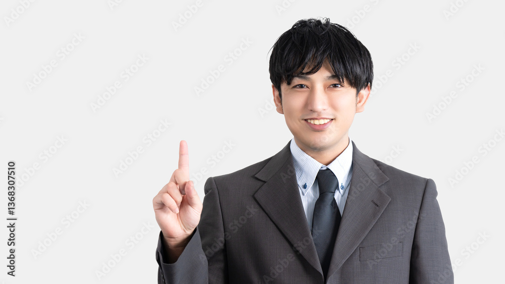 人差し指を立てて案内する男性ビジネスマン 人差し指を立てて案内する男性ビジネスマン