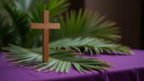 a wooden cross and palm leaves on the table - Palm Sunday