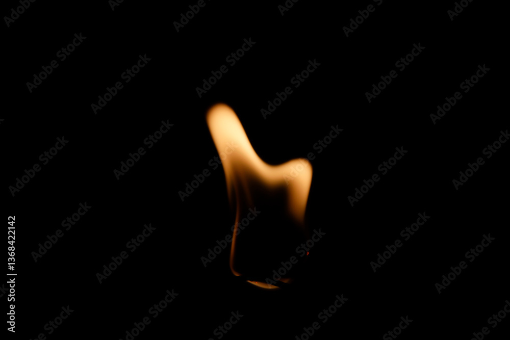 Fototapeta premium Dancing Flame Against Black Background Capturing Flickering Light