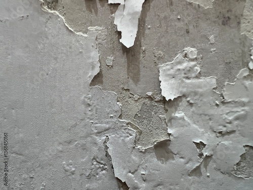 Grunge wall texture. A wall that is damaged and peeling due to water being absorbed into it, so that the wall becomes damp and slightly moldy.