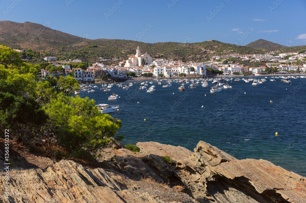 Shallow coastal water and boats facing Cadaques village in Spain