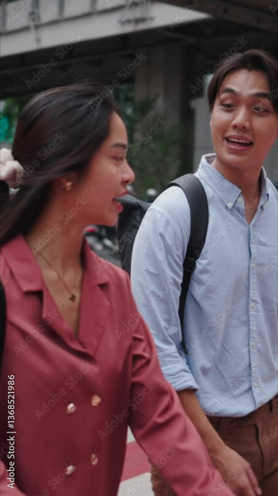Asian students walking and talking at a crosswalk in Bangkok Asian students walking and talking at a crosswalk in Bangkok