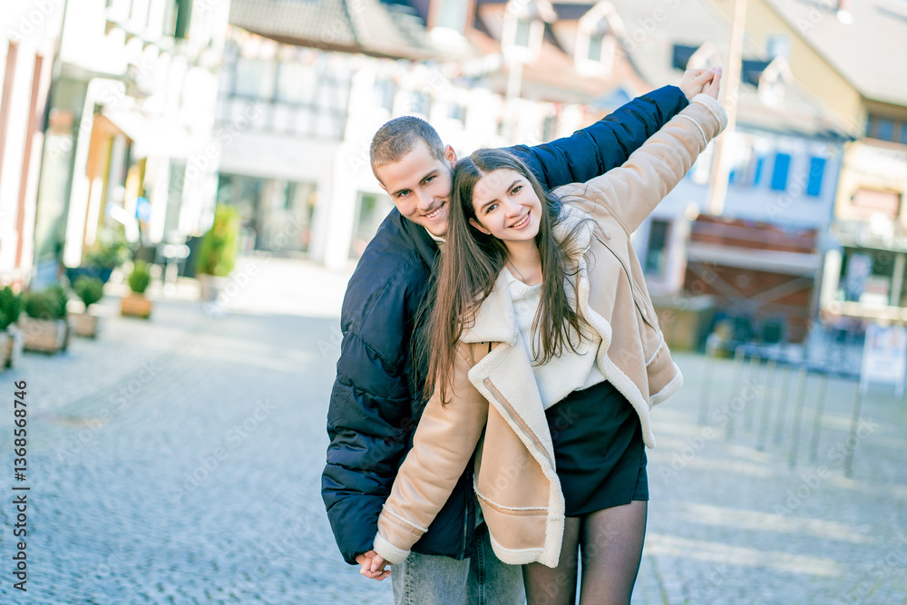 Young beautiful couple in love, happy walking in small European town. Young beautiful couple in love, happy walking in small European town.
