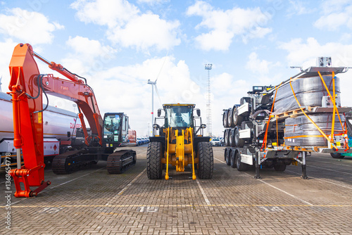 The area of a seaport in Belgium with various heavy vehicles on the premises.