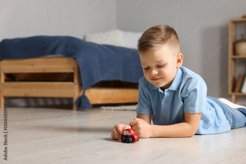 Little boy playing with toy car at home. Space for text Little boy playing with toy car at home. Space for text