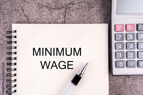 MINIMUM WAGE written on a notepad. Financial management concept
