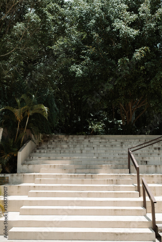Staircase with handrail and trees in the background
