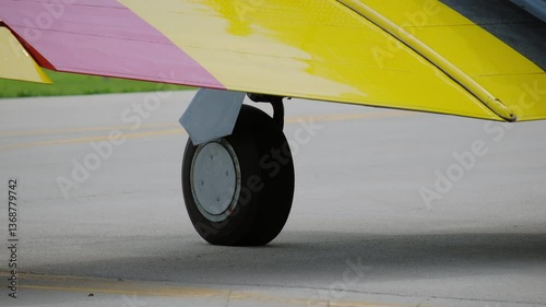 A propeller plane ridding on the taking off lane at the small airport. Green, bright sunny summer day. 