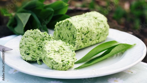 Herb butter with wild garlic on white plate