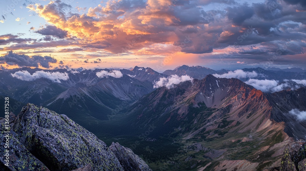 Obraz premium Dramatic sunset over rugged mountain peaks with vibrant orange and purple sky