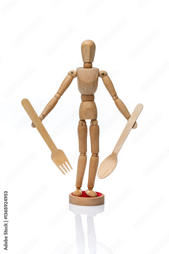 Wooden toy mannequin holding disposable wooden fork and spoon on a white background. Wooden toy mannequin holding disposable wooden fork and spoon on a white background.