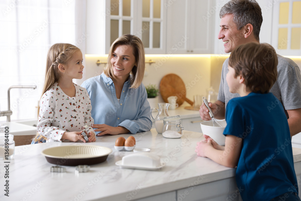 Happy family making dough at white marble table in kitchen Happy family making dough at white marble table in kitchen