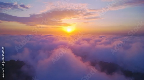 Serene aerial view of sunrise over clouds, dreamy, and peaceful landscape.