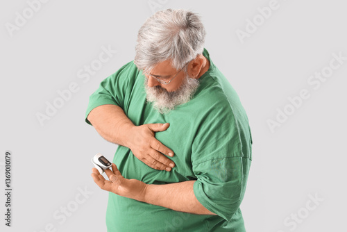 Senior man with pulse oxime...