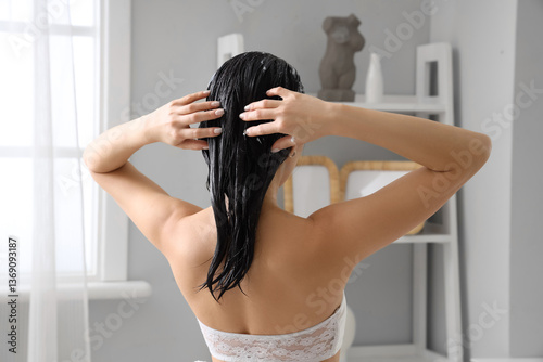 Young woman applying hair m...