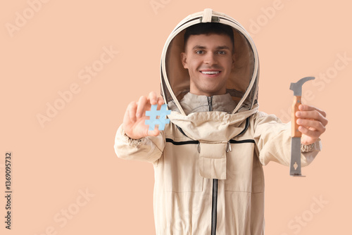 Male beekeeper with tool an...