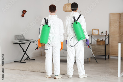 Male workers with disinfect...