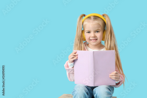 Cute little girl in headpho...