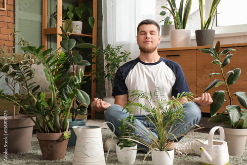 Young handsome man meditati...