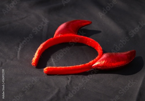 red devil horn headband against black background