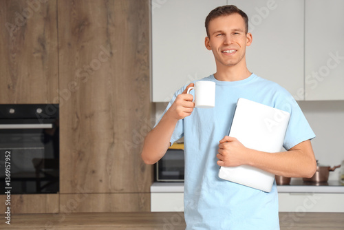 Smiling young man with cup ...