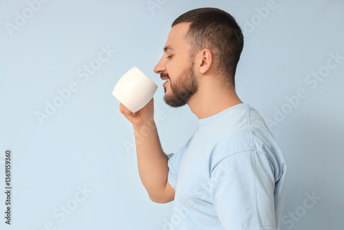 Handsome young man drinking...