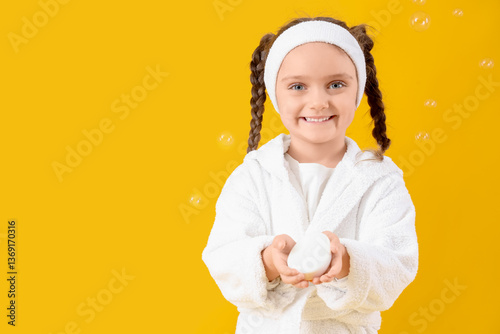Little girl in bathrobe wit...