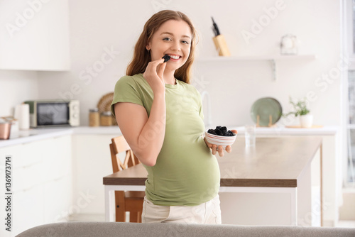 Young pregnant woman eating...