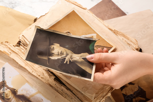 Female hand with old album ...