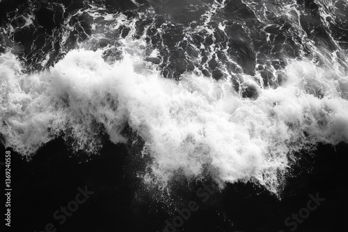 Dynamic black and white photo of ocean waves crashing with intense energy