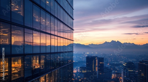 A city skyline at sunset, showcasing modern architecture and distant mountains.