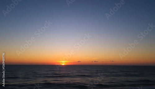 Orange sunset paints the evening sea, reflecting light on gentle waves