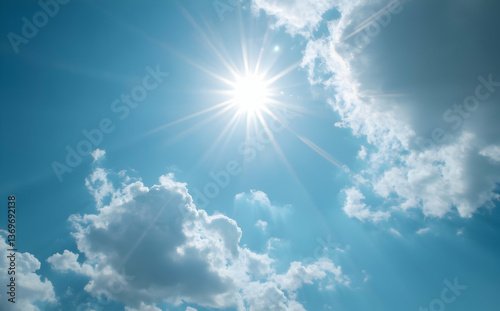 Sun Shining Brightly Through Clouds in the Clear Blue Sky