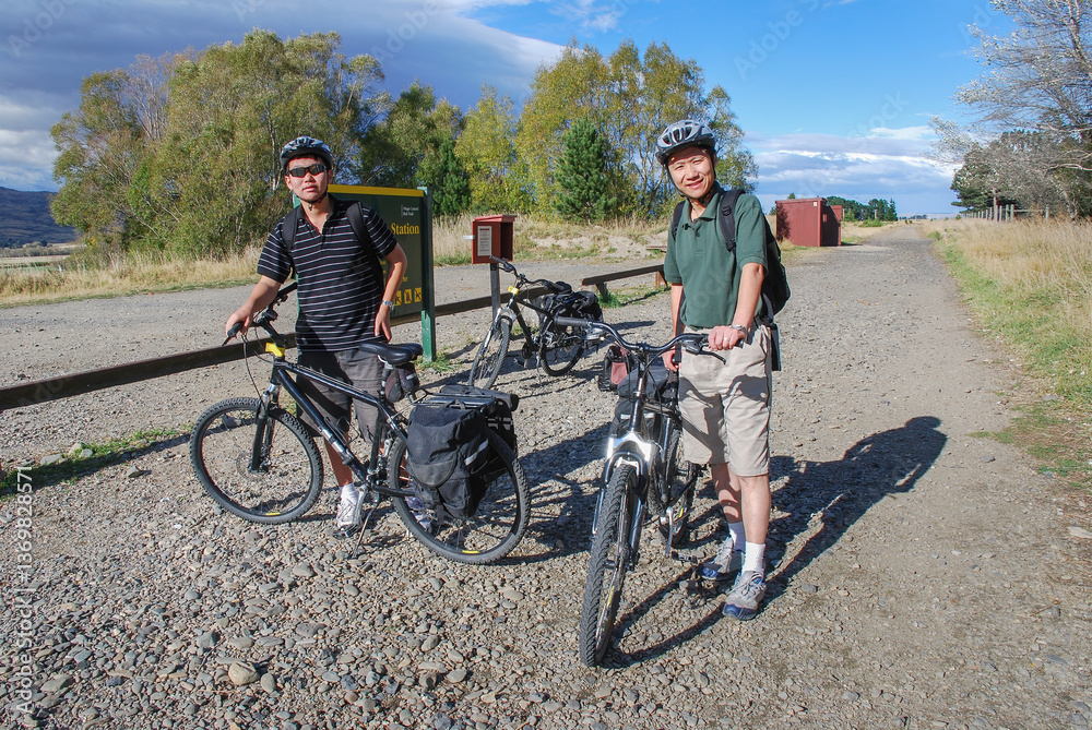 Father and son cyclists getting ready to ride the Otago Central Rail Trail. Central Otago. New Zealand.