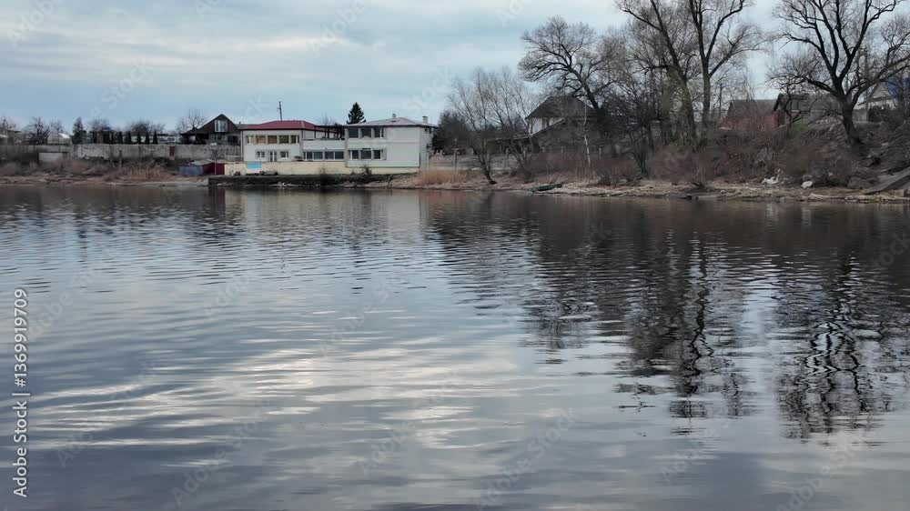 Landscape on the lake shore. Reflection in the river. Sandy bank of the river and dark water. Natural landscape. Walk by the sea. Small waves on the water. Landscape on the lake shore. Reflection in the river. Sandy bank of the river and dark water. Natural landscape. Walk by the sea. Small waves on the water.