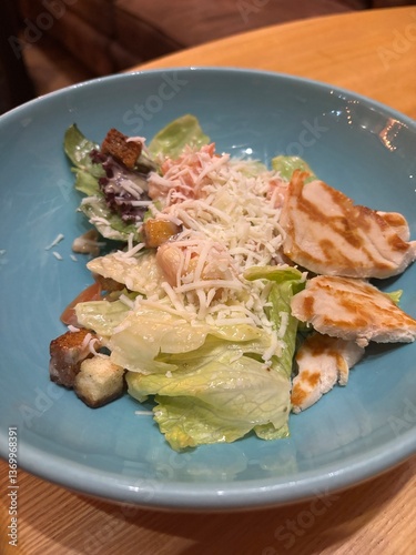 diet salad with herbs and chicken on a plate in a restaurant