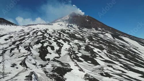 Flying over contrasting volcanic landscape towards summit of Mount Etna, the most active volcano in Europe, located on Sicily Italy
