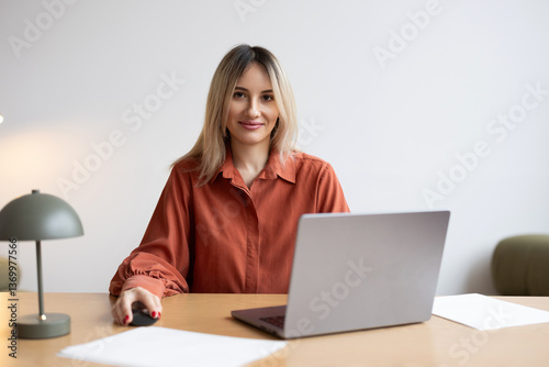 Wallpaper Mural Young woman working on laptop at a desk in a modern indoor office space during daylight Torontodigital.ca