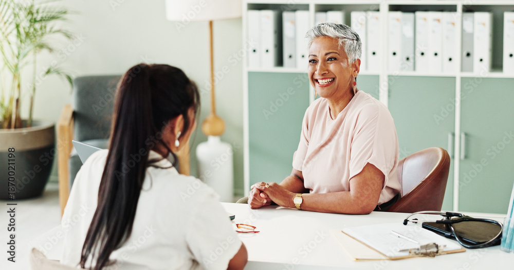 Obraz premium Appointment, healthcare and smile of doctor with patient in office of hospital for consulting. Cardiology, feedback or medical with mature medicine professional and woman in clinic for treatment