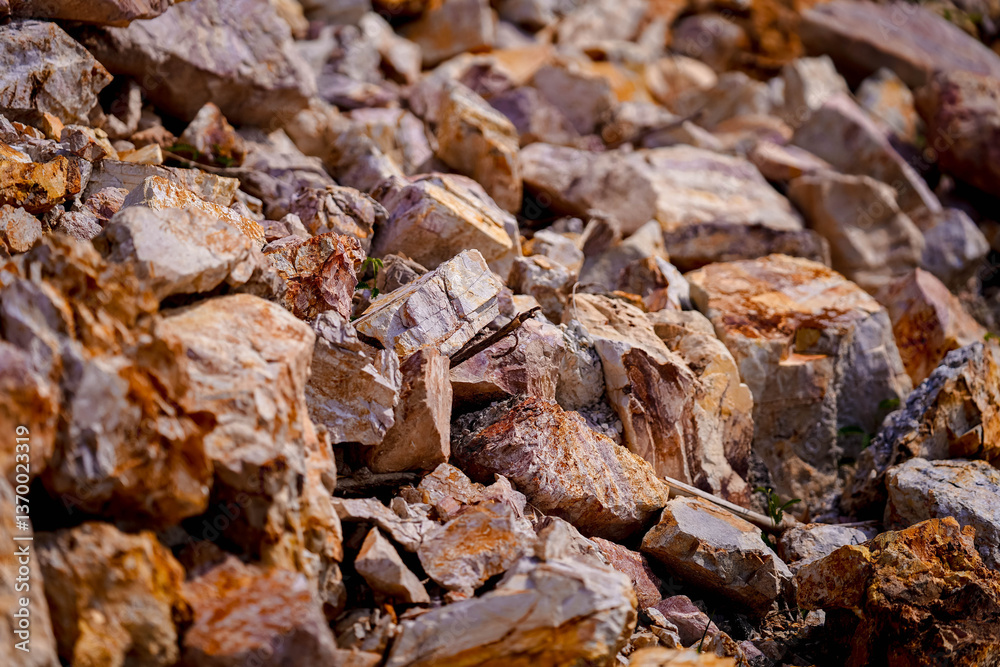 Rough, textured rocks in various shades of brown and gray create natural landscape. sunlight highlights unique patterns and colors, evoking sense of rugged beauty and earthiness Rough, textured rocks in various shades of brown and gray create natural landscape. sunlight highlights unique patterns and colors, evoking sense of rugged beauty and earthiness