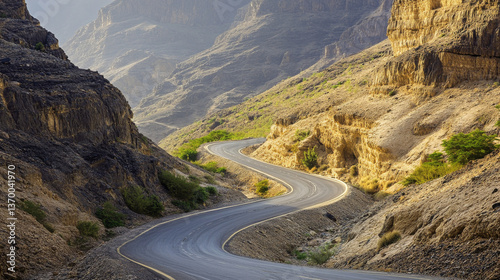 A winding road snakes through the Sultanate of Oman, revealing the rugged beauty of the Arabian Peninsula