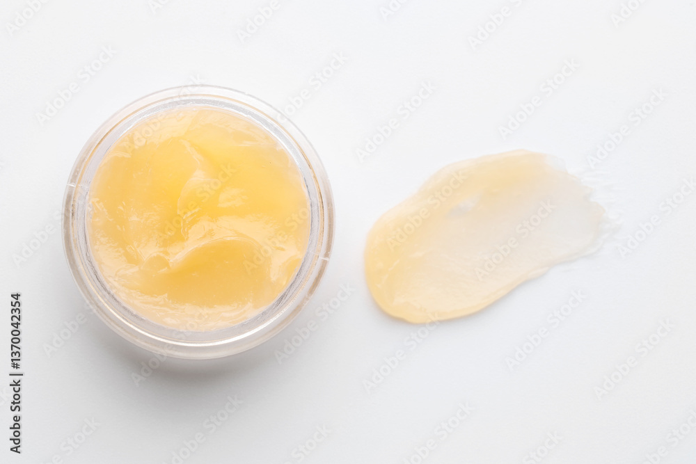 Jar and sample of lip balm on white background, top view Jar and sample of lip balm on white background, top view