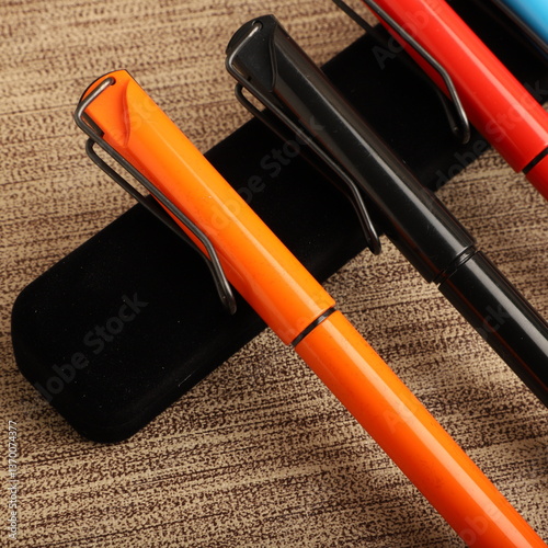 Colorful Assorted Pens Arranged Neatly on a Textured Surface