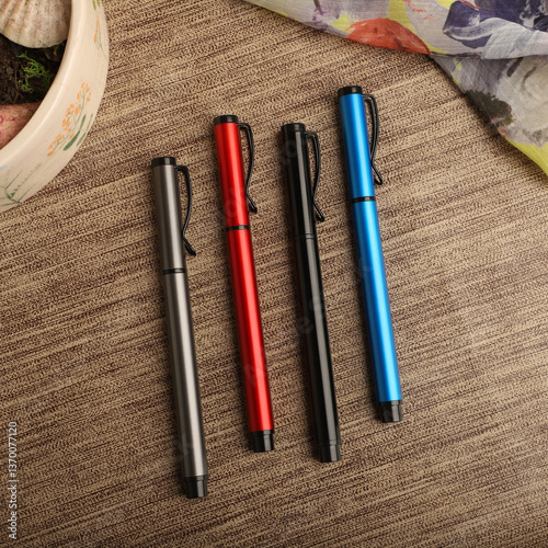 Colorful Assorted Pens Arranged Neatly on a Textured Surface