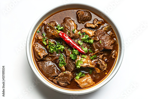 a bowl of stew with meat and a red chili