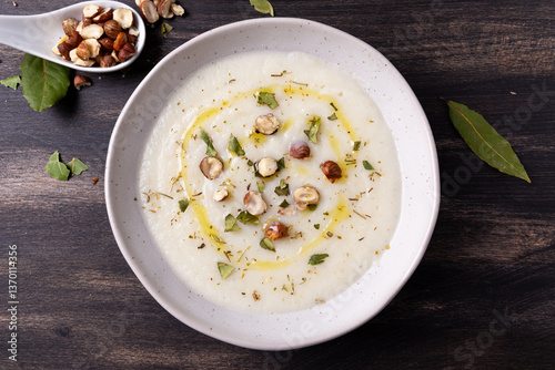 Cauliflower soup with hazelnuts and aromatic herbs. Wnter comfort food and plant based.