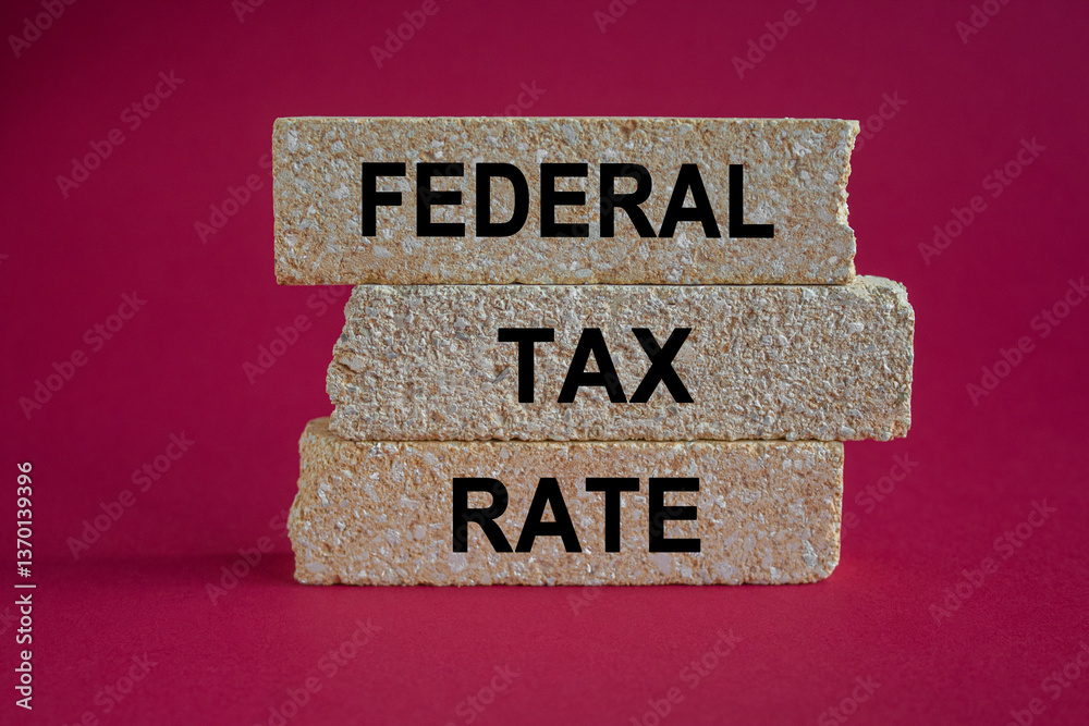 Federal tax rates symbol. Brick blocks with words Federal tax rates. Beautiful red background. Business concept.