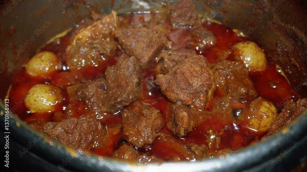 Process of cooking Rendang, an Indonesian food from West Sumatra. Its produced from a long low-temperature cooking process using various spices and coconut milk