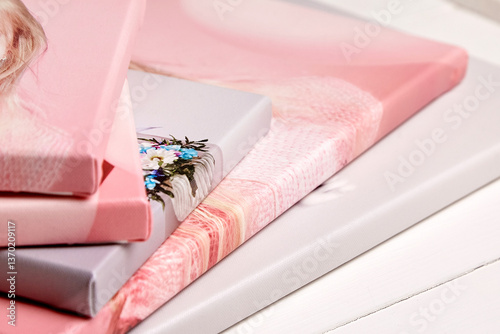 A close-up of stacked canvas prints with gallery wrapping, featuring pastel tones and soft textures. Ideal for modern home decor and personalized wall art